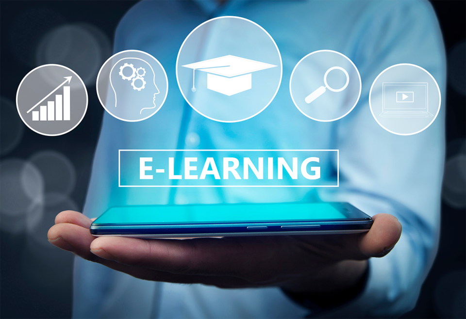 someone's hand who is holding a mobile phone, which has the text "e-learning" and icons such as video icons, graphs, a search facility, and a mortarboard hat, emerging from it